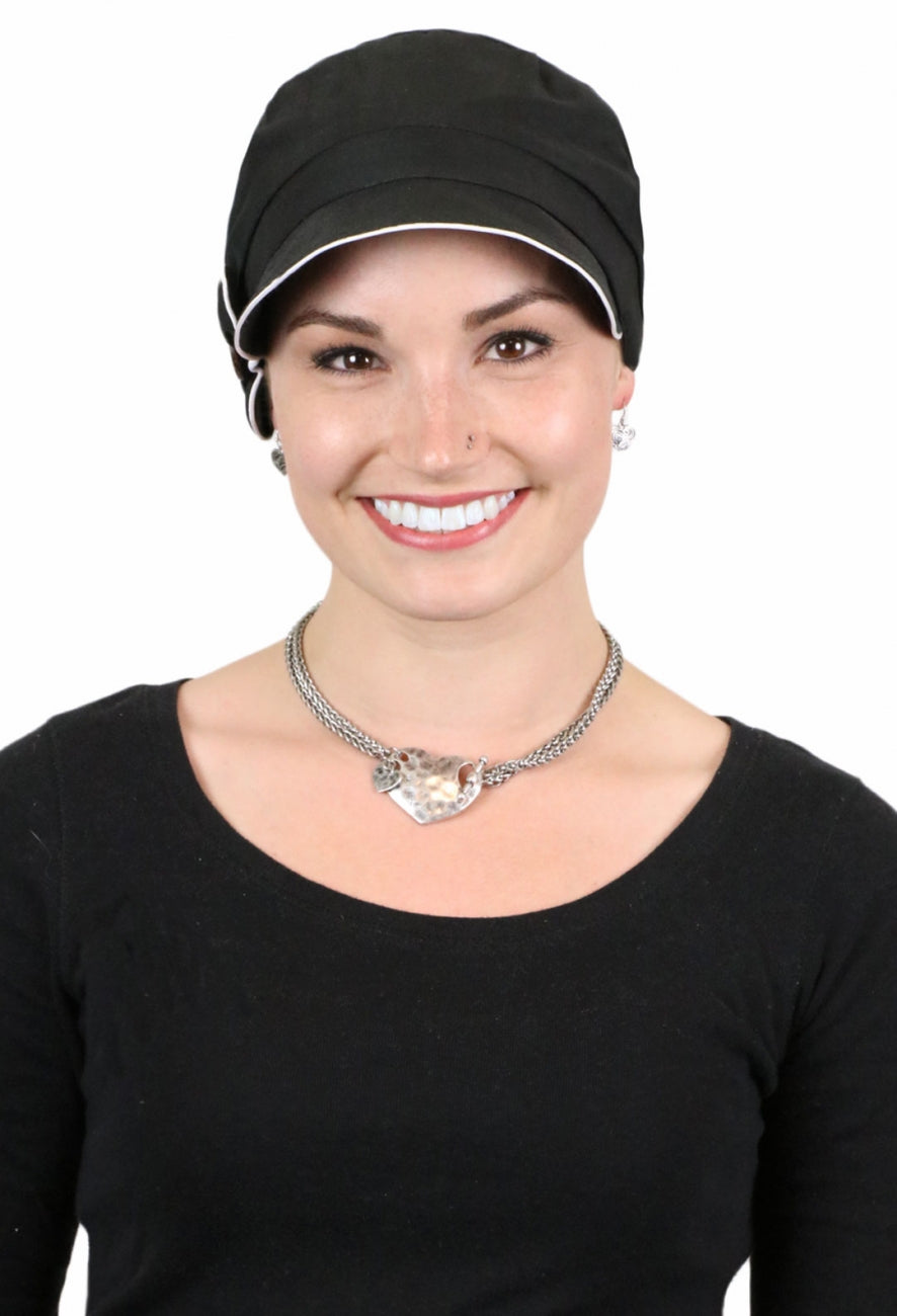 woman in black newsboy cap with white trim