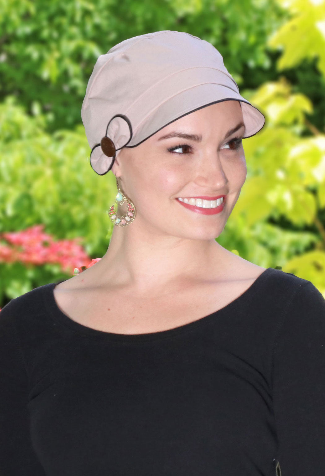 woman in garden wearing beige newsboy cap for chemo patients