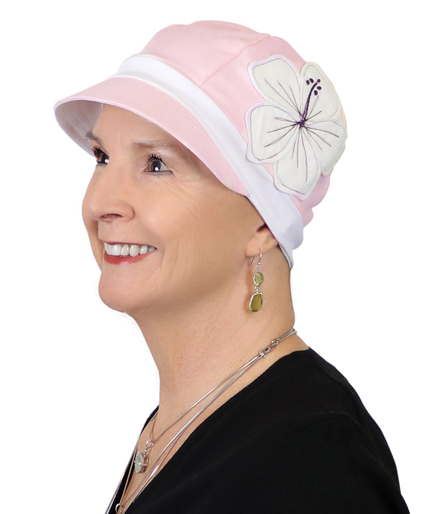 woman in pink cotton baseball style hat for chemo headwear