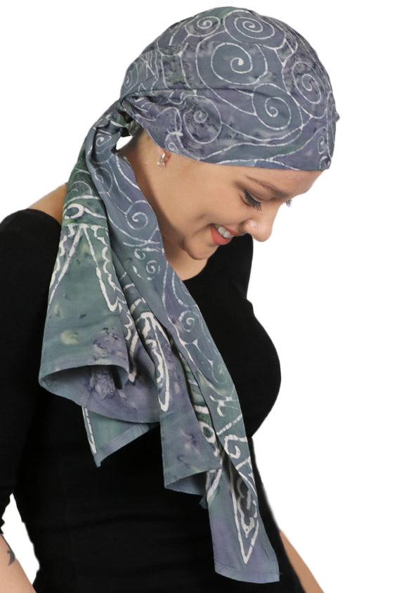 woman wearing long grey headscarf with white swirls