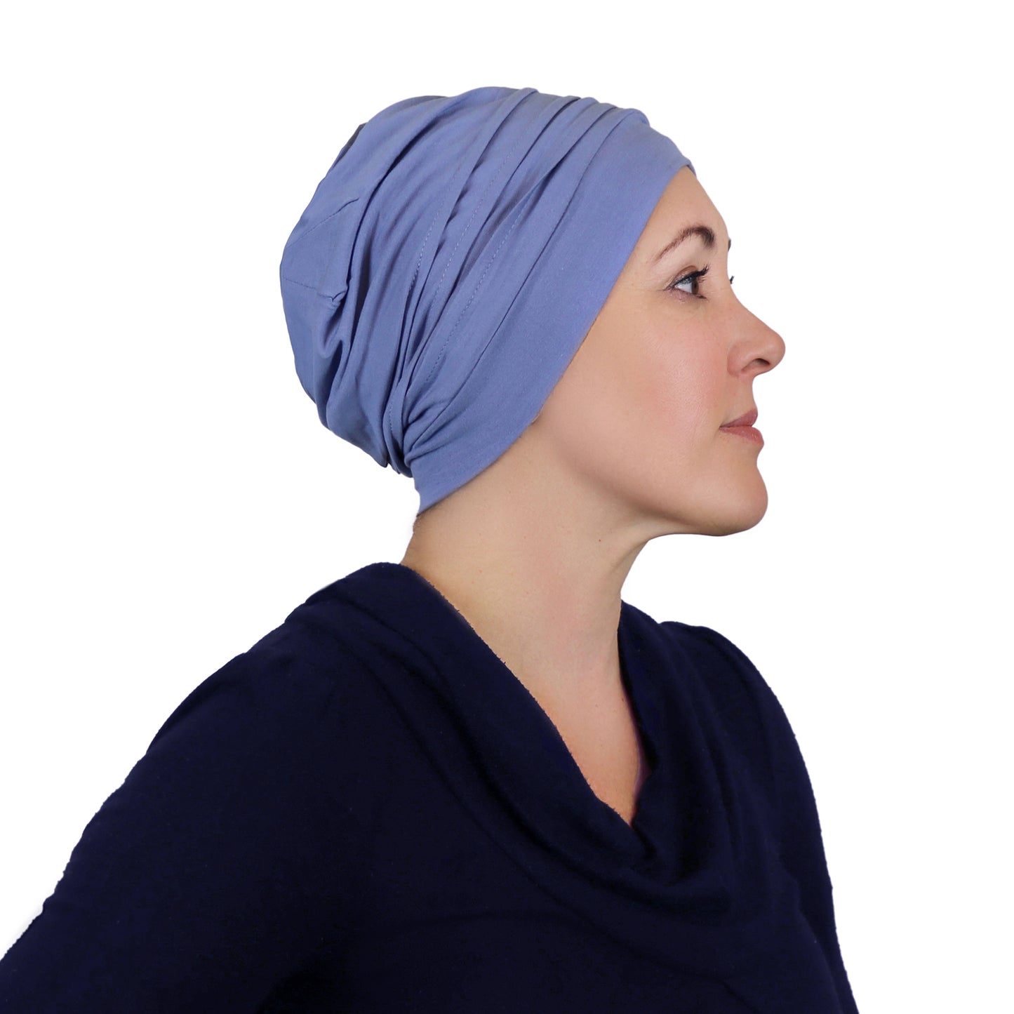 Woman wearing chambray blue slouchy beanie for chemo headwear. Side view showing fullness in the back 