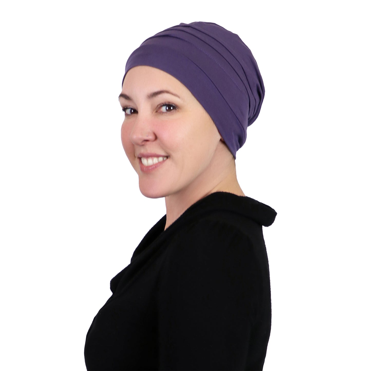 Woman wearing dusty plum slouchy beanie for chemo headwear. Side view showing fullness in the back 