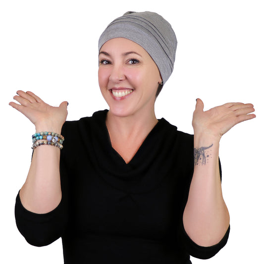 Woman wearing heather grey bamboo chemo beanie and black top 