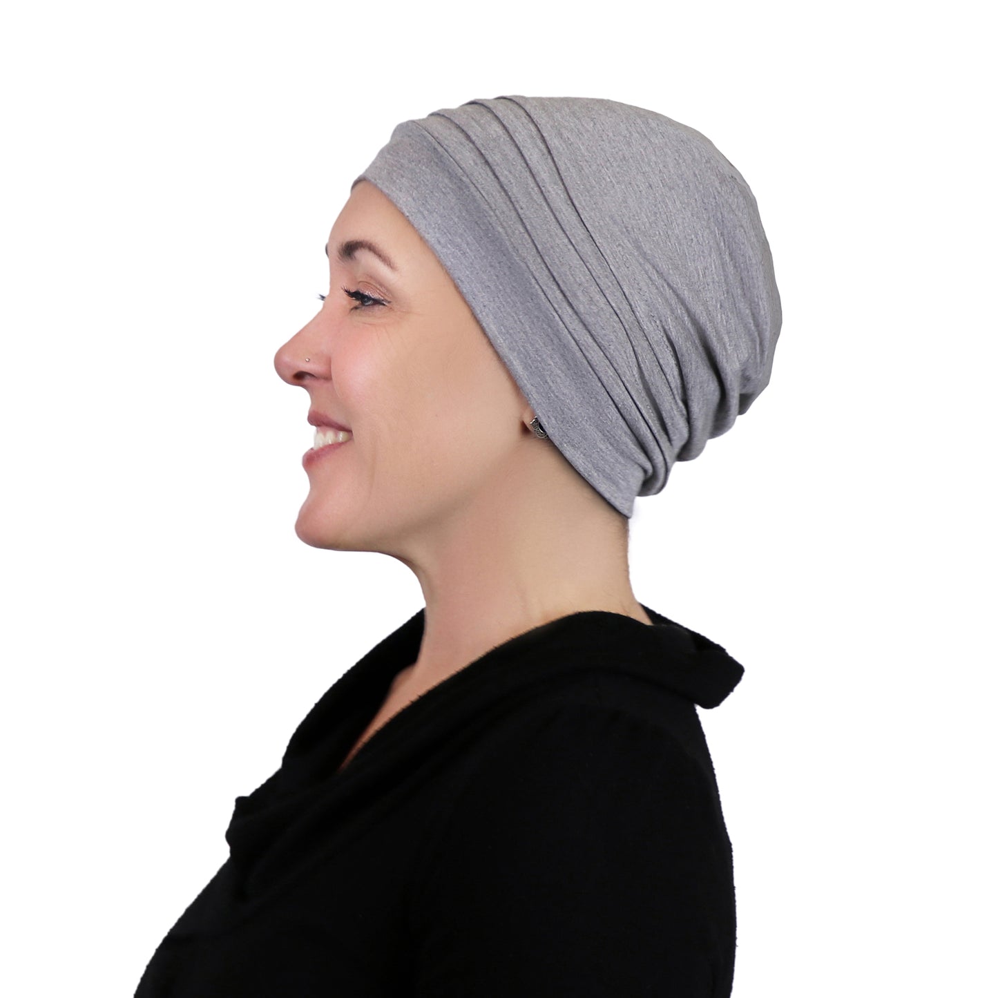 Woman wearing heather grey bamboo slouchy beanie for chemo headwear. Side view showing fullness in the back 