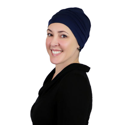 Woman wearing navy blue slouchy beanie for chemo headwear.  