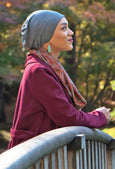woman in Japanese Garden wearing dark grey bamboo slouchy hat for chemo patients