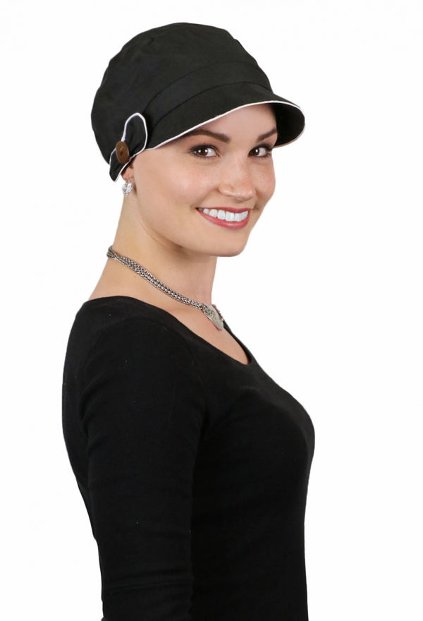 WOMAN IN black newsboy cap with white trim and button detail