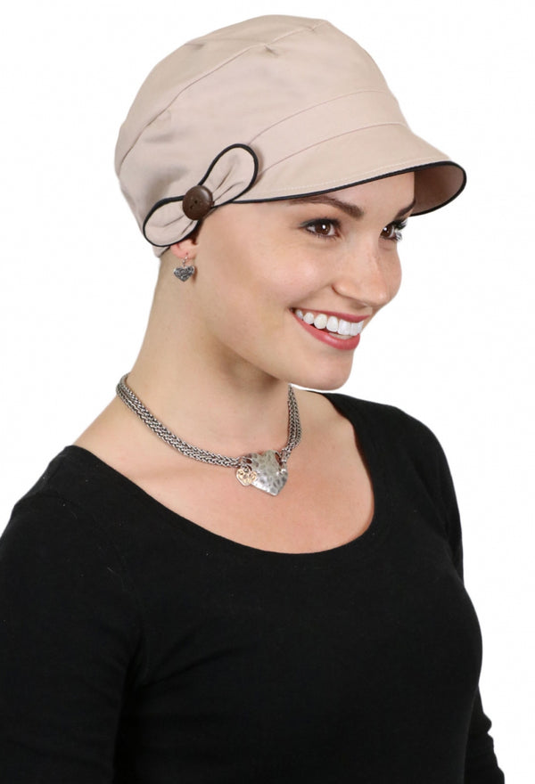 woman wearing beige hat with black trim for chemo patients